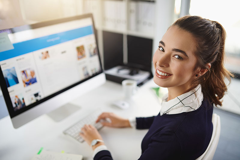 Melbourne business owner updating her website on a desktop computer